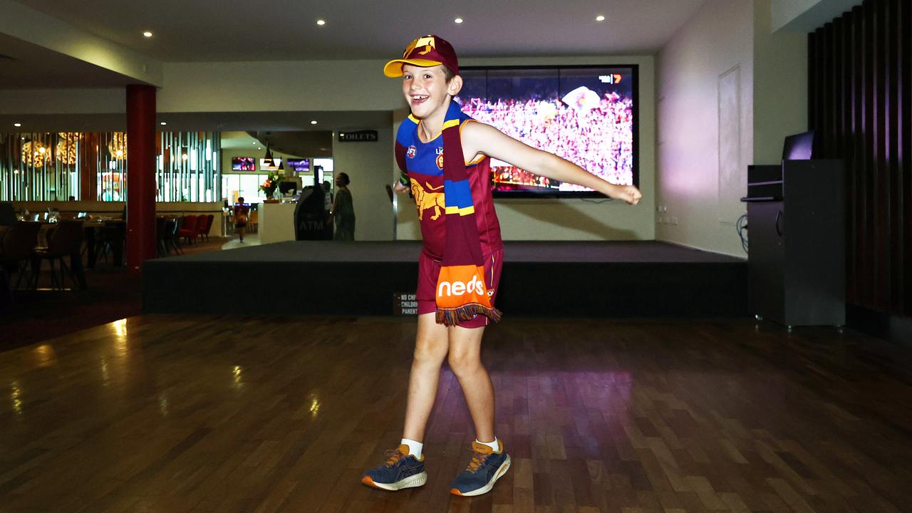 Tate Raby, 8, celebrates the Brisbane Lions scoring a goal as he watches the AFL Grand Final at Cazalys Sports Club. Picture: Brendan Radke