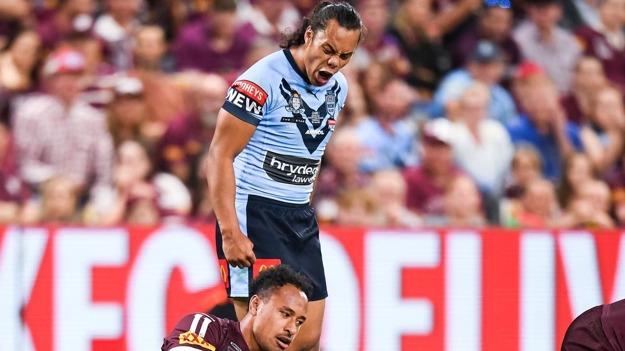 Blues five-eighth Jarome Luai stands over Maroons forward Felise Kaufusi