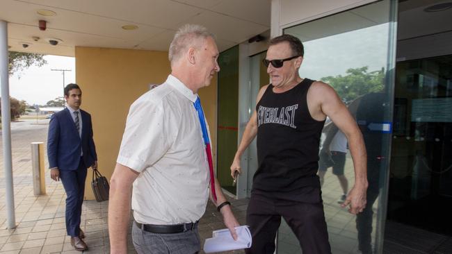 The former local councillor being confronted outside court. Picture: Brett Hartwig