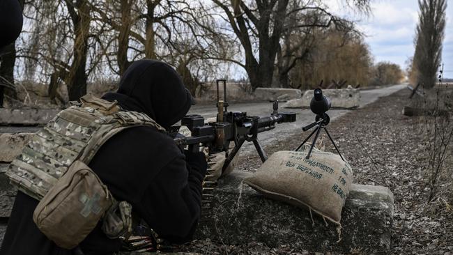 A Ukrainian serviceman takes a bead on Russian positions outside the city of Brovary, east of Kyiv, on Wednesday. Picture: AFP