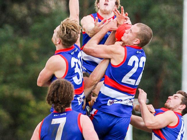 Bendigo Football League round 8 match between Gisborne and Golden Square. Gisborne 15.5(9 defeated Golden Sqaure 9.12 (66). With bodies coming from all angles Jack Reaper (22) somehow manages to haul in a big pack mark for Gisborne. Picture: Aaron Cook