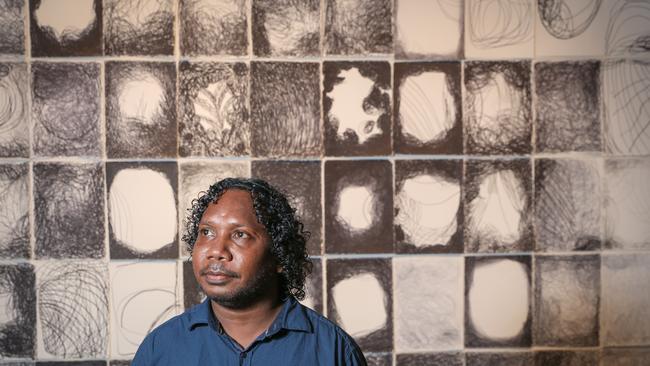 Ishmael Marika in front of his grandmothers award-winning artwork, Ms M Wirrpanda an award winner at the Telstra Indigenous Art awards Picture: Glenn Campbell