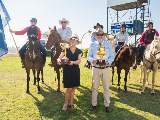 VRC chairman Amanda Elliot with the Emirates Melbourne Cup and the Longreach Jockey Club chairman with the Longreach Cup.