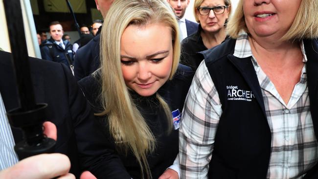 Ms Whelan is rushed to a waiting car to avoid questions from the travelling media pack about Facebook comments. Picture: GARY RAMAGE