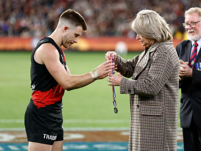 Zach Merrett of the Bombers is presented with the Anzac Medal. Picture: Michael Willson/AFL Photos via Getty Images