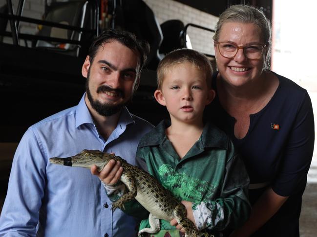 Deputy minister for Parks and Wildlife Andrew Mackay, young croc enthusiast and hopeful pet owner Layne, and Minister for Parks and Wildlife Marie-Clare Boothby with Burtie the juvenile crocodile. Picture: Sam Lowe