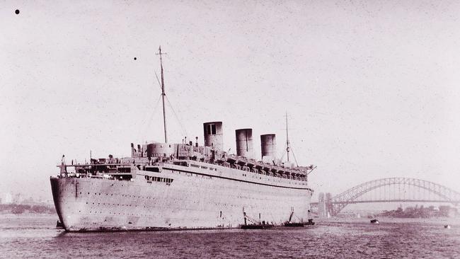 Former cruise ship the Queen Mary, decked out in her camouflage dull grey paint, arrives in Sydney Harbour in 1940.