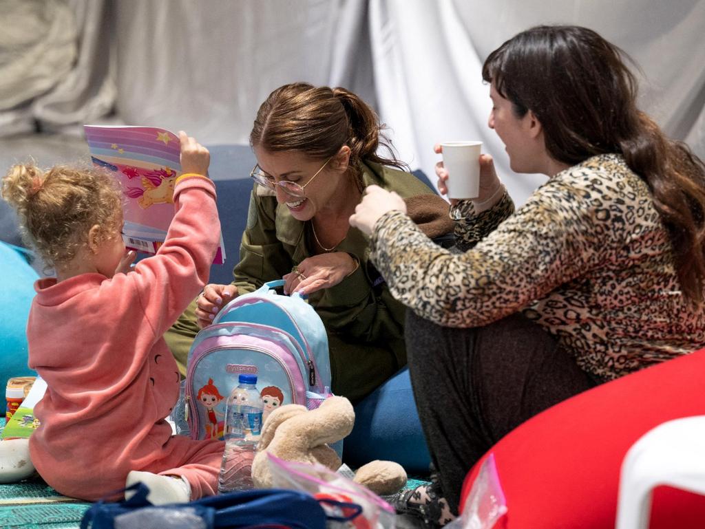 Israeli German former hostage Adi Shoham, 38, sitting next to her daughter Yahel Neri and an Israeli soldier after their release. Picture: Israeli Government Press Office / AFP