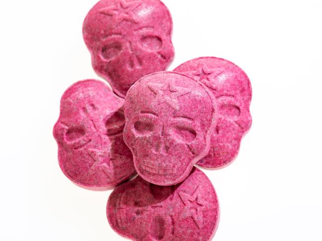 Five Red Army Skull, Ecstasy, MDMA or medication pills shaped like a skull isolated on a white background.