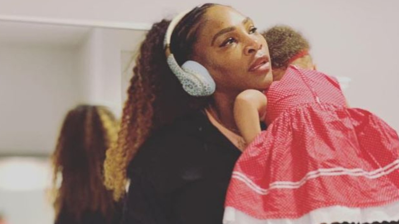 Serena Williams gives her daughter Olympia a cuddle.