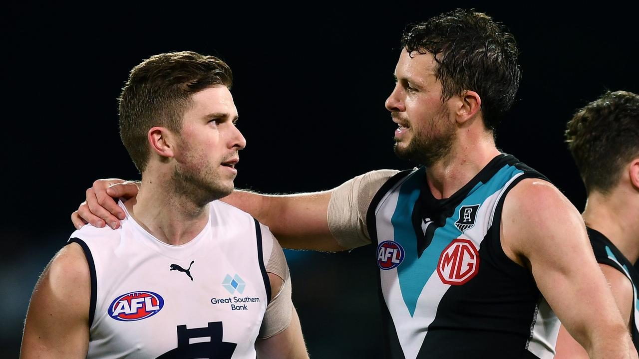 Travis Boak congratulates Marc Murphy on his 300th game at the final siren.