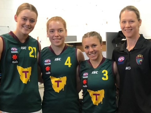 Mia King (second from left) and coach Deb Reynolds (right) during the North Melbourne AFLW star’s Tasmania Devils days in 2019. Picture: Supplied