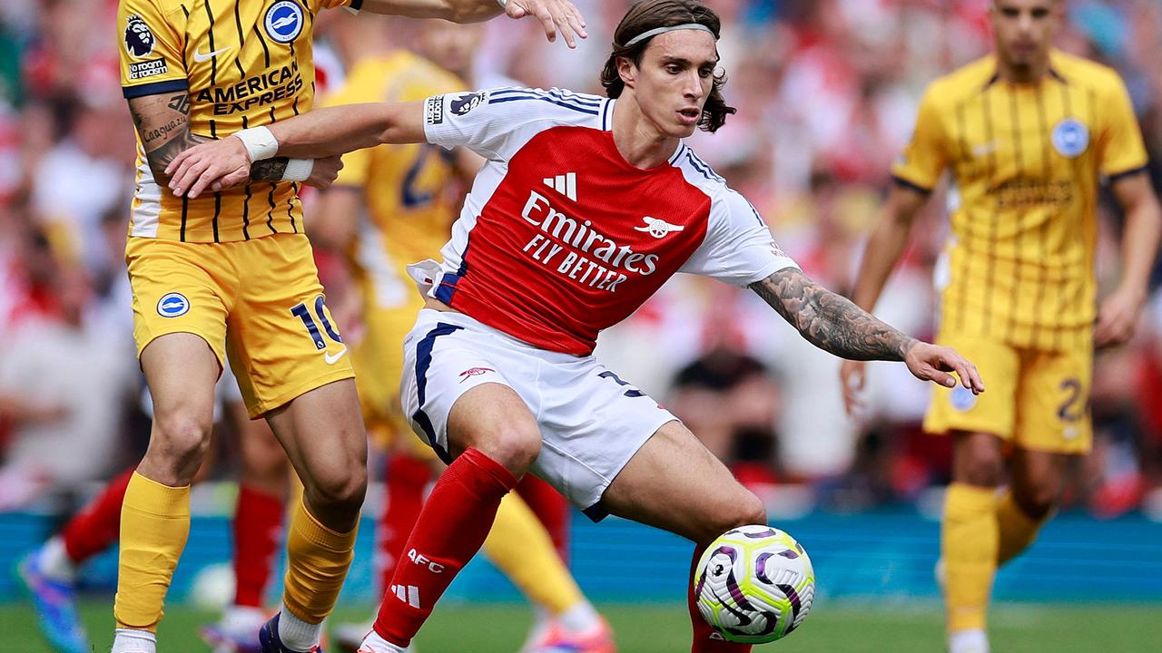 Arsenal's Italian defender Riccardo Calafiori challenges for the ball with Brighton's Paraguayan attacker Julio Enciso during a English Premier League match between the Emirates Stadium.