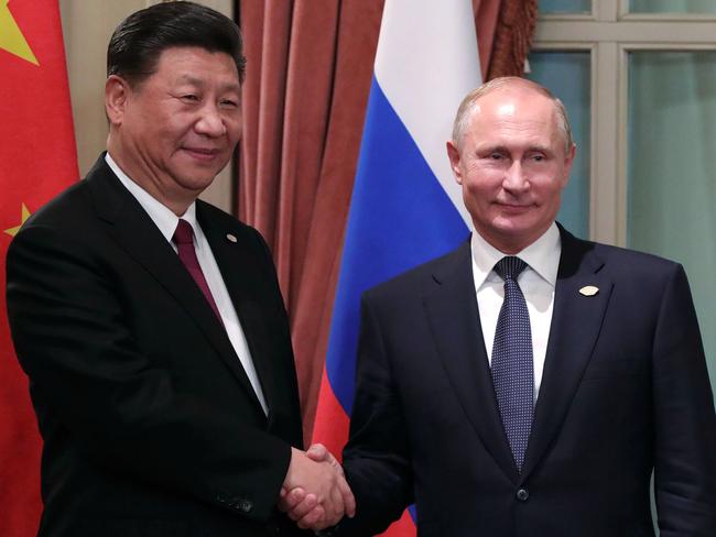 China's President Xi Jinping (L) and Russia's President Vladimir Putin shake hands, during a bilateral meeting in the sidelines of the G20 Summit in Buenos Aires, on November 30, 2018. - Global leaders gather in the Argentine capital for a two-day G20 summit beginning on Friday likely to be dominated by simmering international tensions over trade. (Photo by Mikhael Klimentyev / SPUTNIK / AFP)