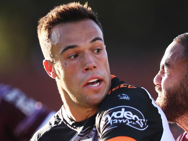 Tiger's Luke Brooks offloads during NRL match Manly Sea Eagles v Wests Tigers at Brookvale oval. Picture. Phil Hillyard