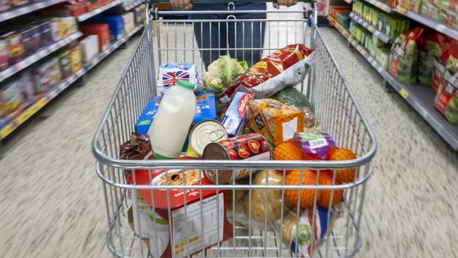 CARDIFF, WALES - MAY 22: A woman with a shopping trolley full of groceries in a supermarket aisle on May 22, 2022 in Cardiff, Wales. Last week, the UK Office for National Statistics reported an 6% average increase of food and drink prices year on year, but some staples, such as milk and pasta, had risen by more than 10%. (Photo by Matthew Horwood/Getty Images)