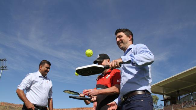 NT people, sport, and culture minister Jinson Charles, Alice Springs Pickleball founder Greg Clarke, and NT planning minister Josh Burgoyne show off their pickleball skills at Albrecht Oval, Larapinta, Alice Springs, May 2, 2025. Picture: Gera Kazakov