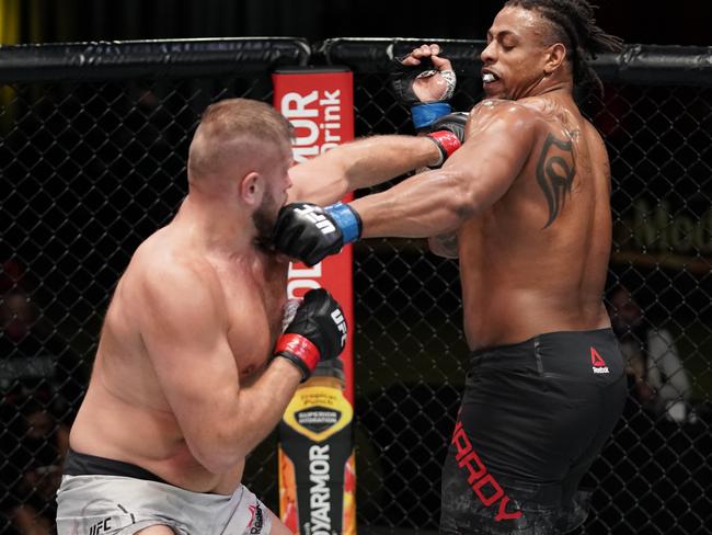 LAS VEGAS, NEVADA - DECEMBER 19: In this handout image provided by UFC, (L-R) Marcin Tybura of Poland and Greg Hardy trade punches in a heavyweight fight during the UFC Fight Night event at UFC APEX on December 19, 2020 in Las Vegas, Nevada. (Photo by Cooper Neill/Zuffa LLC via Getty Images)