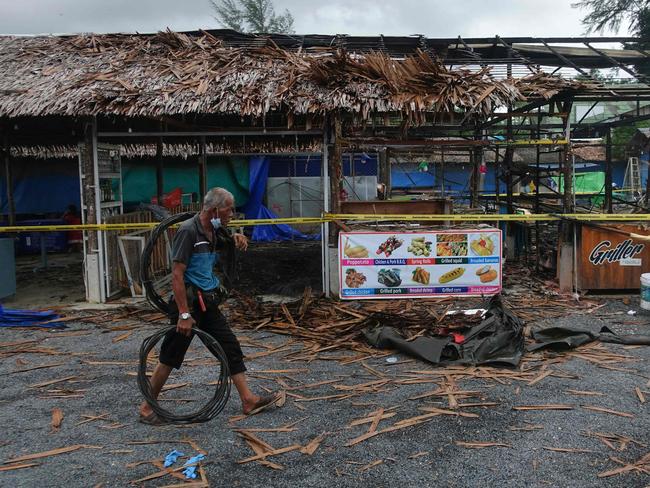 A man walks past the site of a small bomb blast and arson attack on Bang Niang market, Takua Pa, near Khao Lak in Phang Nga province of Thailand.  Picture:  AFP