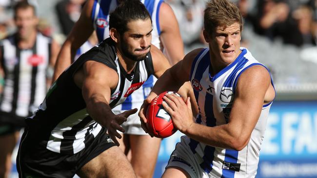 Kangaroo Nick Dal Santo bursts clear of Magpie Brodie Grundy. Picture: Wayne Ludbey