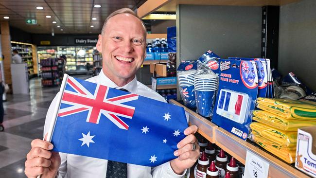 John-Paul Drake with an Australia Day flag in his Wayville store. Picture: Brenton Edwards