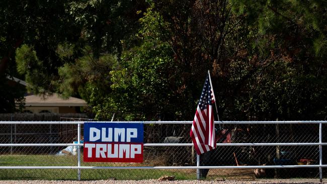 A "Dump Trump" sign hangs from a fence in Gilbert, Arizona. Picture: Getty Images