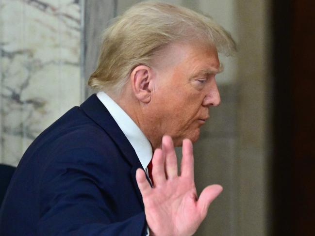 (FILES) Former US President Donald Trump waves after speaking to the media during the third day of his civil fraud trial in New York on October 4, 2023. Former US President Donald Trump on October 6, 2023, denied reports in US media that he had shared US nuclear submarine secrets with an Australian businessman in a meeting at his Florida mansion shortly after leaving office. The New York Times, citing unnamed sources, identified the entrepreneur as billionaire Anthony Pratt, who heads one of the world's largest packaging companies. (Photo by ANGELA WEISS / AFP)