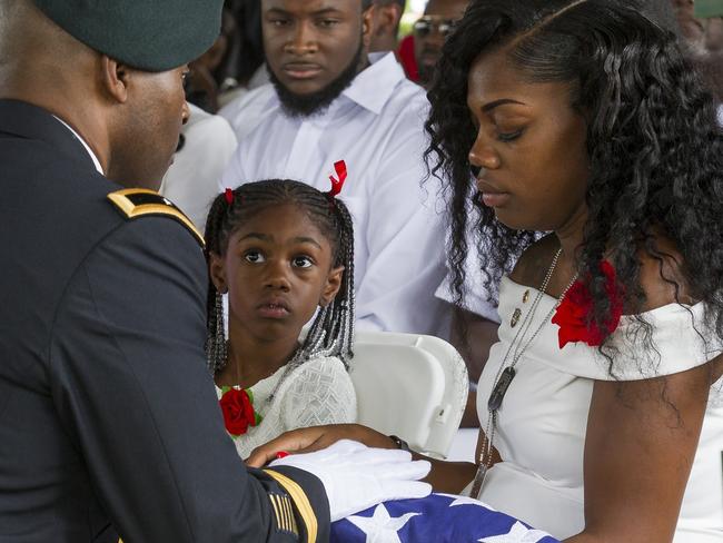 Myeshia Johnson is presented with the U.S. flag that was draped over the casket of her husband. Picture: AP