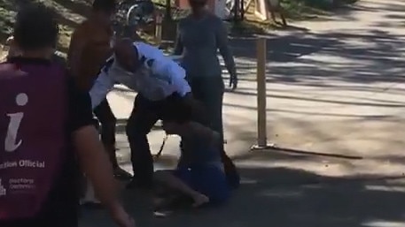 Footage has emerged of two men fighting on a footpath outside a polling booth in Redbank.