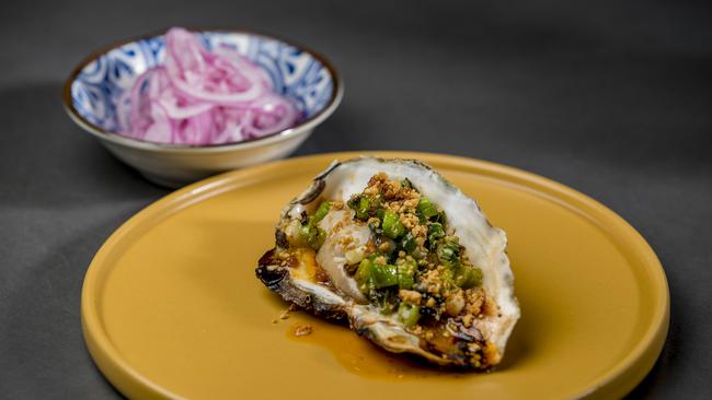 Robina’s Eddy + Wolff restaurant: the jumbo oyster and scallion oil with roasted crushed peanuts. Picture: Jerad Williams