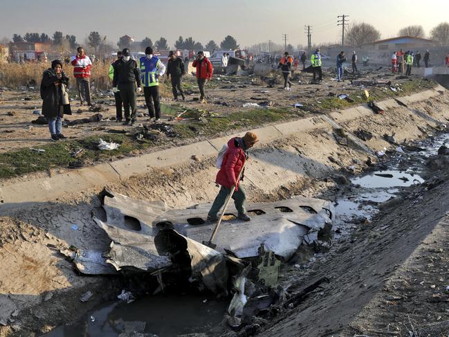 Rescue workers inspect the scene where a Ukrainian plane crashed in Shahedshahr, southwest of the capital Tehran, Iran. Picture: AP