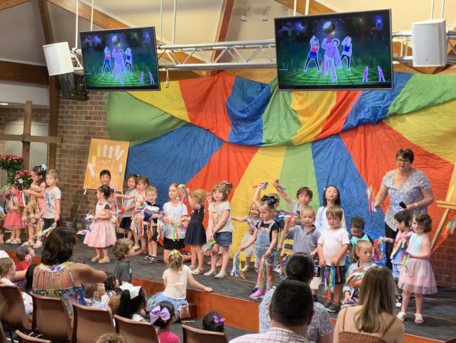 Children perform a song during the anniversary event.