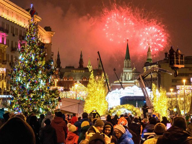 People look at fireworks exploding over the Kremlin in Moscow. Picture: AFP