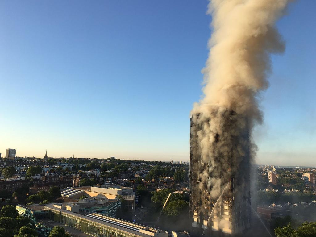 A handout image given to local resident Natalie Oxford early on June 14 showing flames and smoke coming from the 27-storey apartment block, which has 120 flats. Picture: AFP Photo/Natalie Oxford