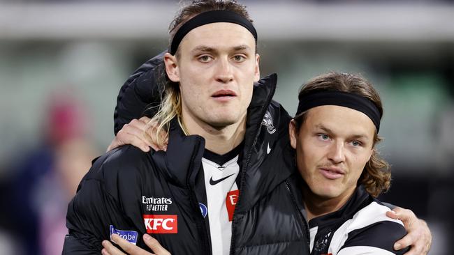 MELBOURNE, AUSTRALIA - AUGUST 11: Jack Ginnivan of the Magpies shares an embrace with Darcy Moore of the Magpies as Moore is subbed out of the game during the round 22 AFL match between Collingwood Magpies and Geelong Cats at Melbourne Cricket Ground, on August 11, 2023, in Melbourne, Australia. (Photo by Darrian Traynor/Getty Images)