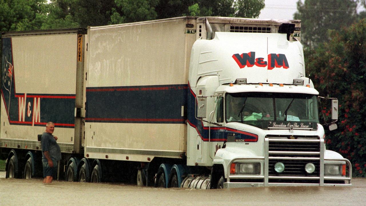 Truck drivers moved on as the flood waters in Gympie, Queensland, receded. 10 February 1999.