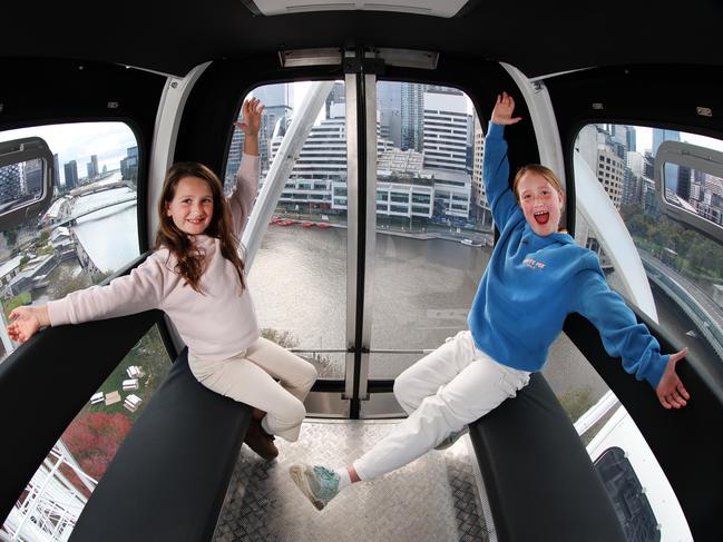 Sisters Grace, 7, and Isabella, 9, get a sneak peek oat the wheel looking over the CBD. Picture: David Caird