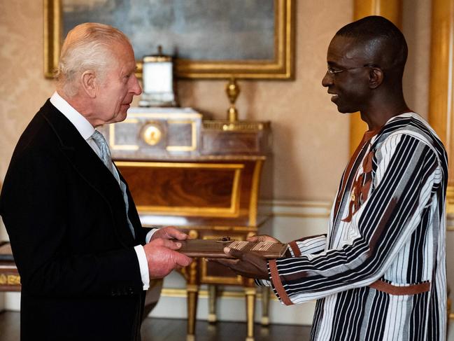 Burkina Faso's ambassador to the UK Leopold Tonguenoma Bonkoungou (R) presents his credentials to King Charles III during a private audience at Buckingham Palace. Picture: AFP