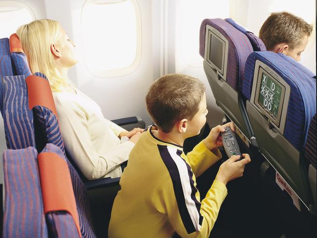 Qantas airline 747-400 aircraft interior, entertainment and communication system upgrades. Child economy class passenger playing computer game 03 Jul 2001. /Qantas/Airways/Ltd