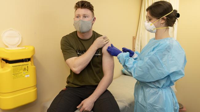 Jackson Gray, 21, receives his first AstraZeneca vaccination from Dr Phoebe Norville in Campbelltown, southwest Sydney, on Thursday. Picture: Nikki Short