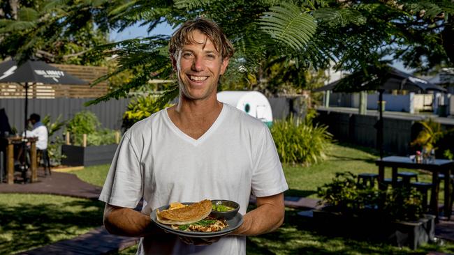 Cameron Chartres holding the famous Stones Throw Saag Aloo Hash dish. Picture: Jerad Williams.