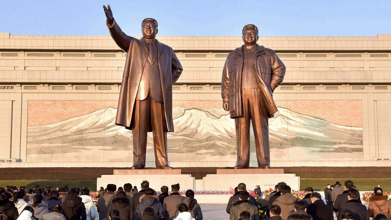 North Koreans gathering to pay their respects before the statues of late North Korean leaders Kim Il Sung and Kim Jong Il. Picture: AFP/ South Korea OUT.