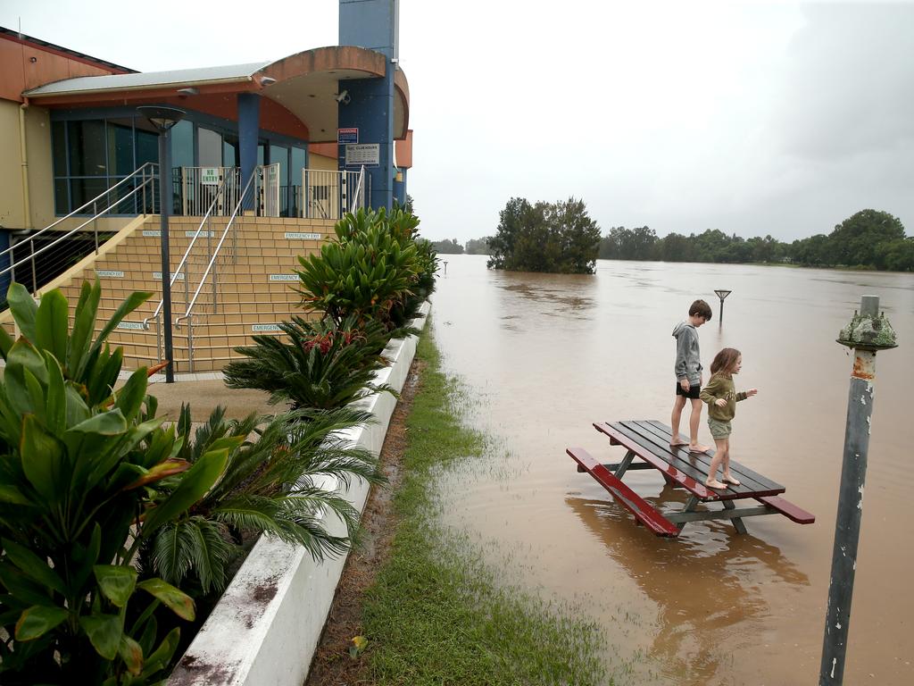 Kempsey residents watch the rising water at the town’s levy wall. Picture: Nathan Edwards