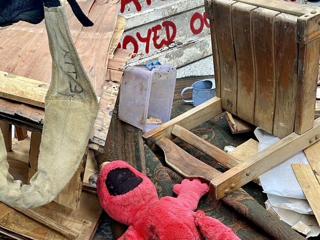 A stuffed Emo soft toy found in the aftermath of the Lismore floods is among the pile of debris dumped at Kirribilli House Picture: @XRebellionAus on Twitter