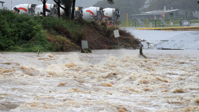 The causeway at Maudsland Dr, Oxenford on the Gold Coast was blocked to all traffic due to flood waters which caused severe damage to fences and the road surfaces. Picture: NCA NewsWire/Scott Powick