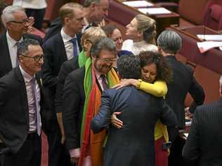 Coalition Senator Dean Smith receives a hug from Labor Senator Malarndirri McCarthy after the same-sex marriage bill passed the Senate in the Senate chamber at Parliament House in Canberra, Wednesday, November 29, 2017. Picture: LUKAS COCH-AAP