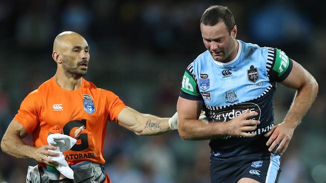 Boyd Cordner assisted by a trainer after a head knock.