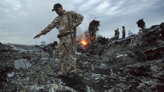 People walking amongst the debris at the crash site of MH17. Picture: Dmitry Lovetsky