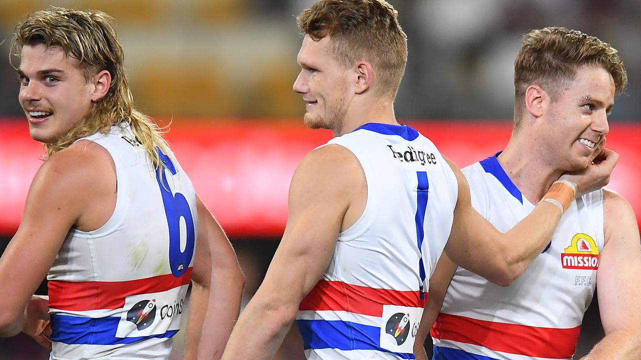 Adam Treloar, centre, celebrates the Bulldogs finals win over Brisbane with Bailey Smith and Lachie Hunter, despite producing one of the poorest performances of his career.