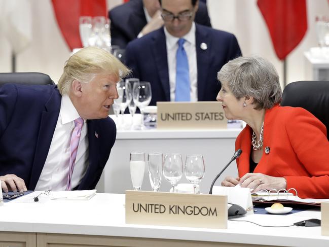 U.S. President Donald Trump, left, speaks to Britain's Prime Minister Theresa May prior to a working lunch at the Group of 20 (G-20) summit in Osaka, Japan, Friday, June 28, 2019. (Kiyoshi Ota/Pool Photo via AP)
